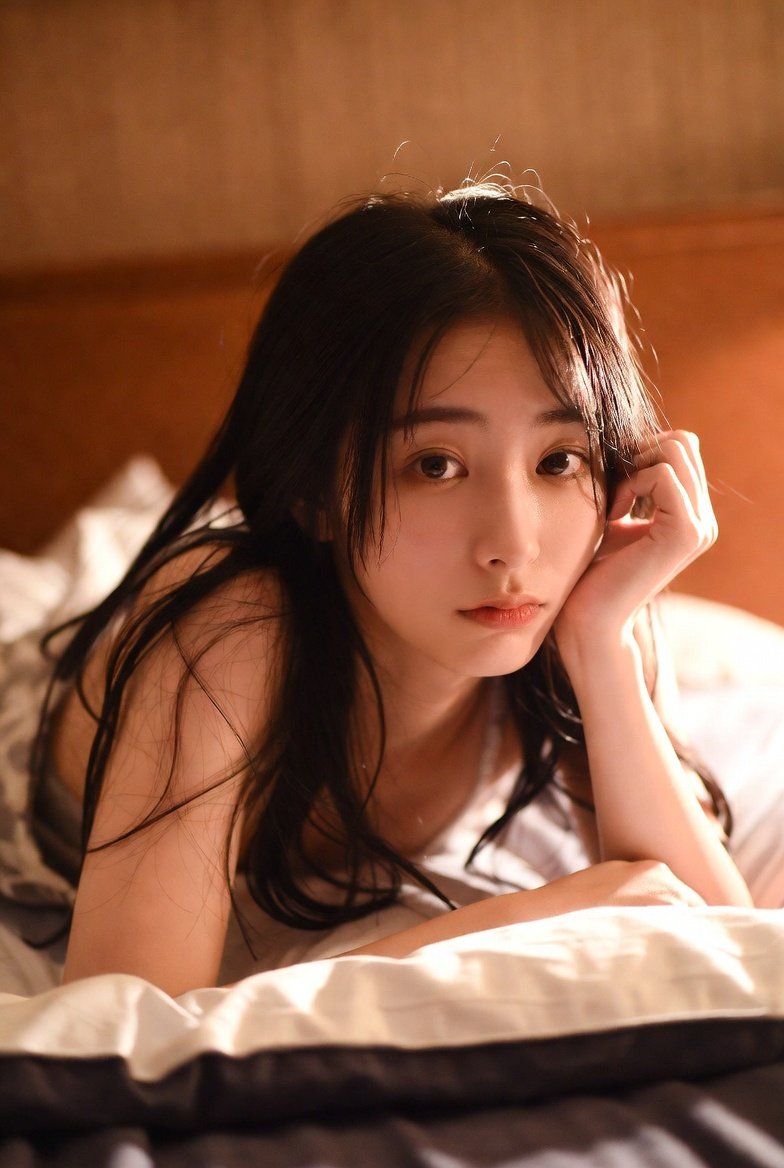 Relaxed Pose of a Young Japanese Woman in a Warm Bedroom